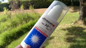 Experienced Senior Buries Bottle Of Sunscreen on Slope